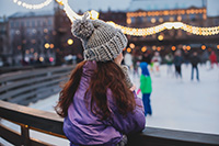 Girl watching skaters at the ice rink