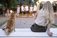 Woman and dog outside watching friends play games