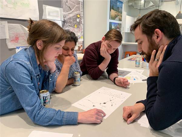 Group reviewing designs on paper