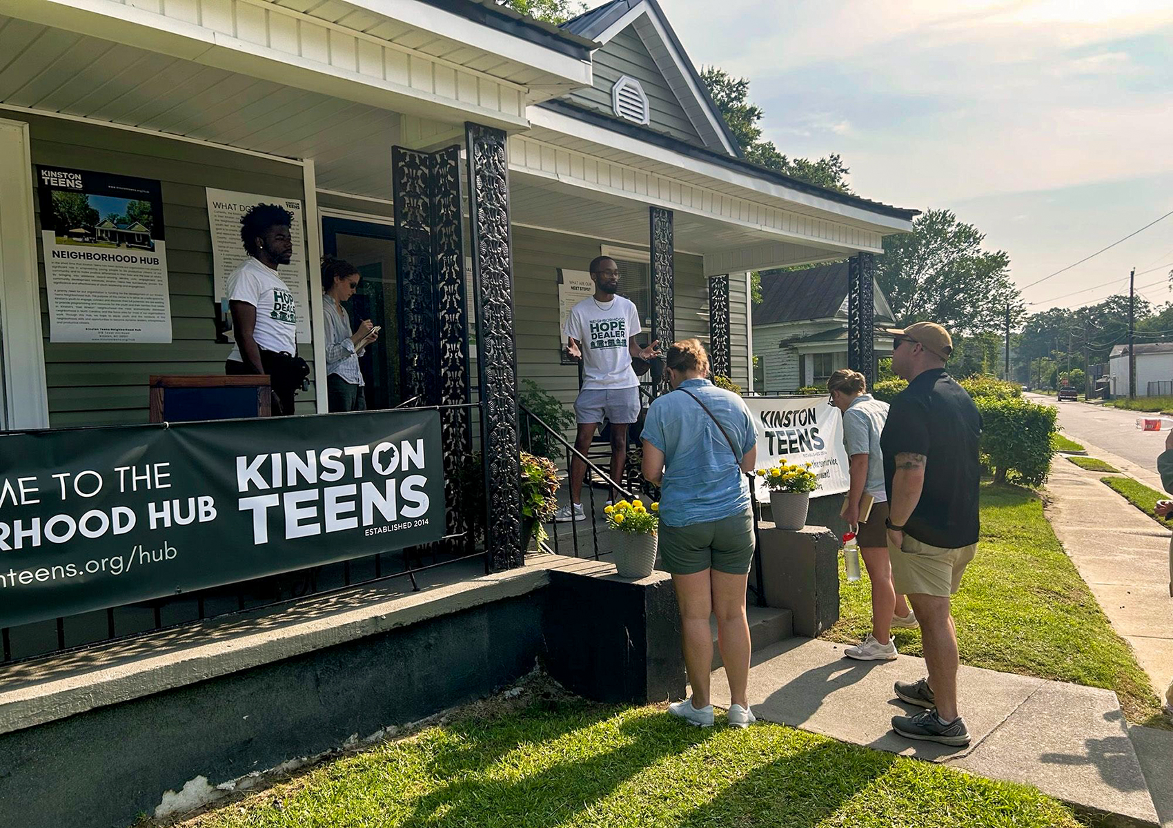 Chris Suggs talks to community members in front of the Kinston Teens office