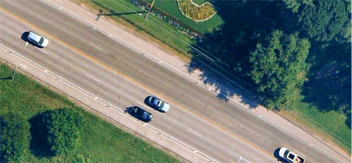 Aerial view of the road with cars, with vegetation along the sides