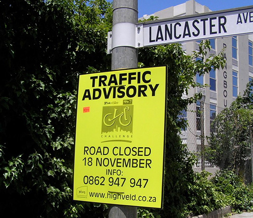 Road Closed signs and cones blocking access to a street