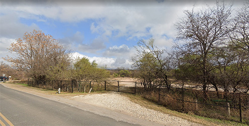 Existing view of road alongside water, showing minimal connection